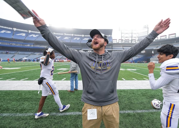 Then-Fitzgerald head coach Tucker Pruitt pumps the crowd up during the final minutes of their GHSA class AA championship game on Friday, Dec. 10, 2021, at Center Parc Stadium in Atlanta. (Daniel Varnado for the AJC)