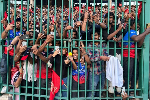 Fans gather to celebrate Royal Challengers Bengaluru cricketers, winners of the Indian Premier League, at the M. Chinnaswamy Stadium in Bengaluru, India, Wednesday, June 4, 2025. (AP Photo/Aijaz Rahi)