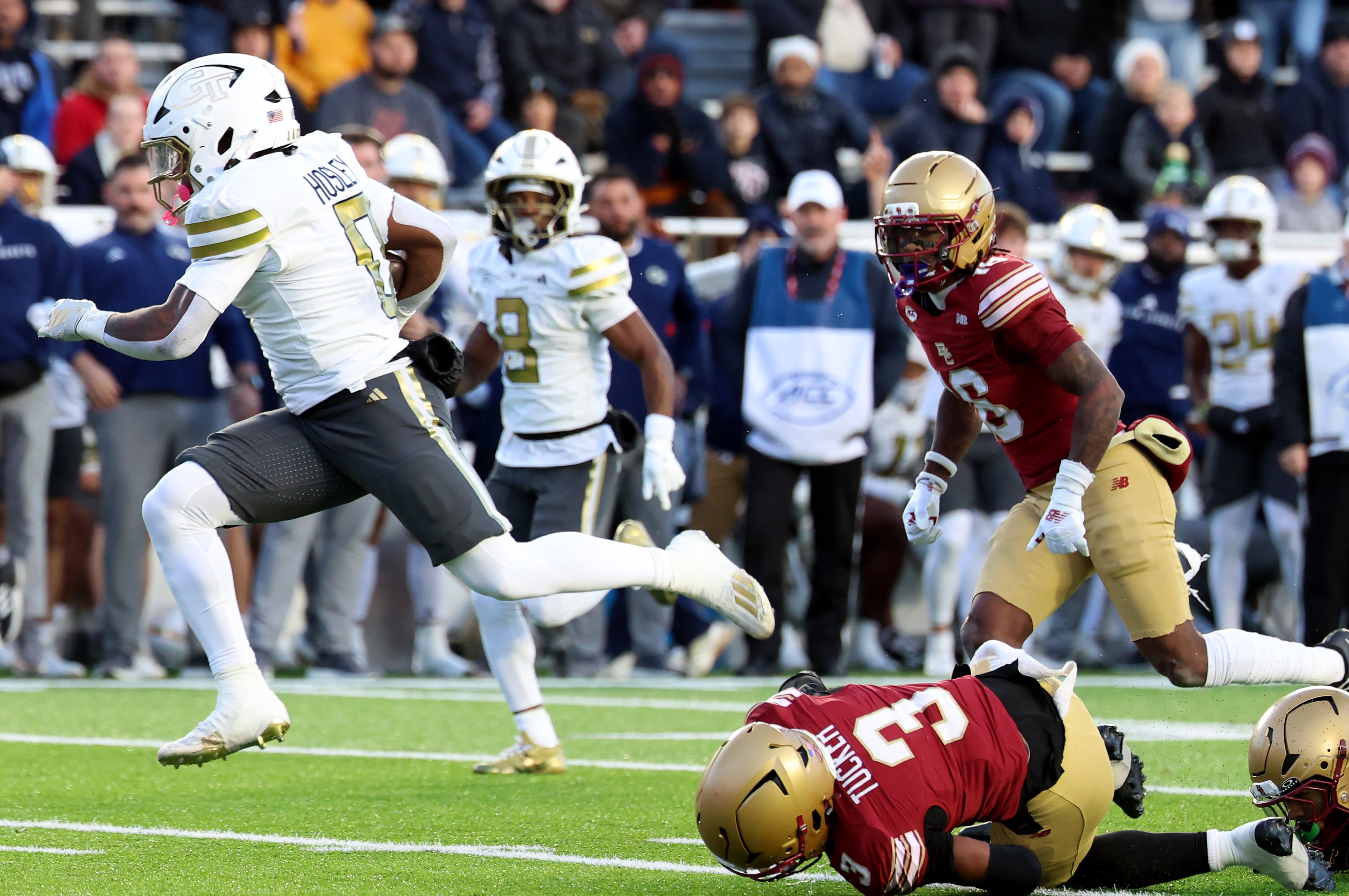 Georgia Tech running back Malachi Hosley, left, runs past Boston College defensive back Max Tucker (3) to score a touchdown during the first half of an NCAA college football game Saturday, Nov. 15, 2025, in Boston. (AP Photo/Mark Stockwell)