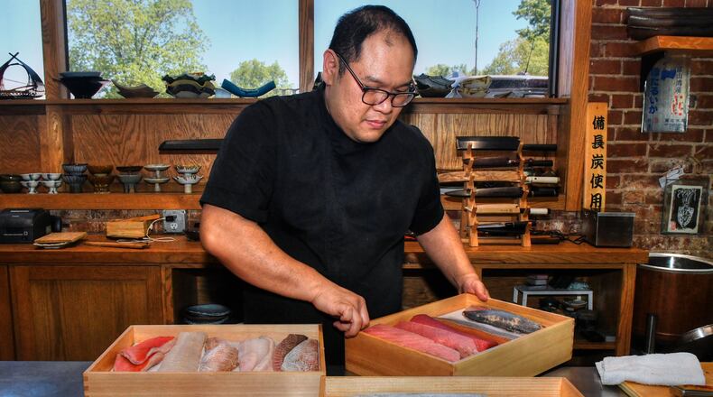 Chef Leonard Yu prepares neta boxes that display the fish for guests and keep it chilled prior to dinner service at his Decatur pop-up, Omakase Table.  (CHRIS HUNT FOR THE ATLANTA JOURNAL-CONSTITUTION)