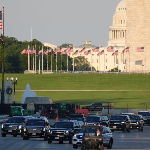 The motorcade with President Donald Trump drives in the Lincoln Memorial Reflecting Pool as he arrives to to see the new blue protective coating being applied as part of a renovation project, Thursday, May 7, 2026, in Washington. (AP Photo/Mark Schiefelbein)