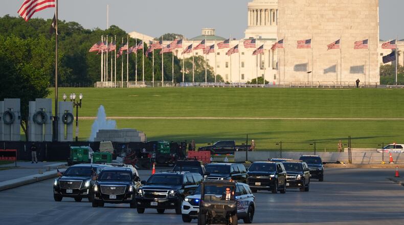 The motorcade with President Donald Trump drives in the Lincoln Memorial Reflecting Pool as he arrives to to see the new blue protective coating being applied as part of a renovation project, Thursday, May 7, 2026, in Washington. (AP Photo/Mark Schiefelbein)