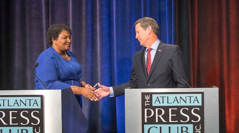 10/23/2018 -- Atlanta, Georgia -- Georgia Gubernatorial Democratic candidate Stacey Abrams and Republican candidate Brian Kemp greet each other before a live taping of the 2018 Gubernatorial debate for the Atlanta Press Club at the Georgia Public Broadcasting studio in Atlanta, Tuesday, October 23, 2018.  (ALYSSA POINTER/ALYSSA.POINTER@AJC.COM)