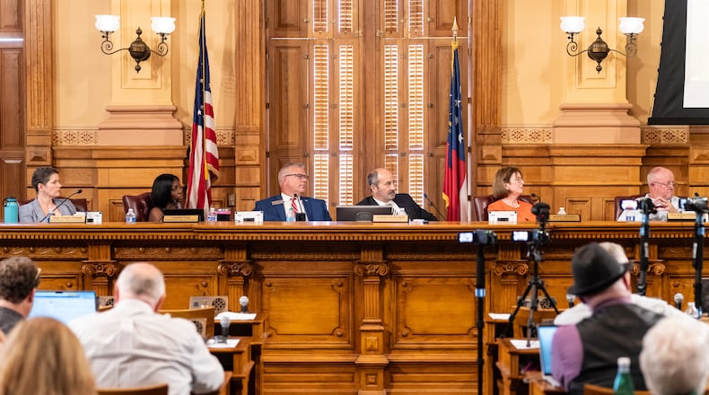 Members of the State Election Board listen to public comment during a meeting Tuesday at the Georgia Capitol in Atlanta.