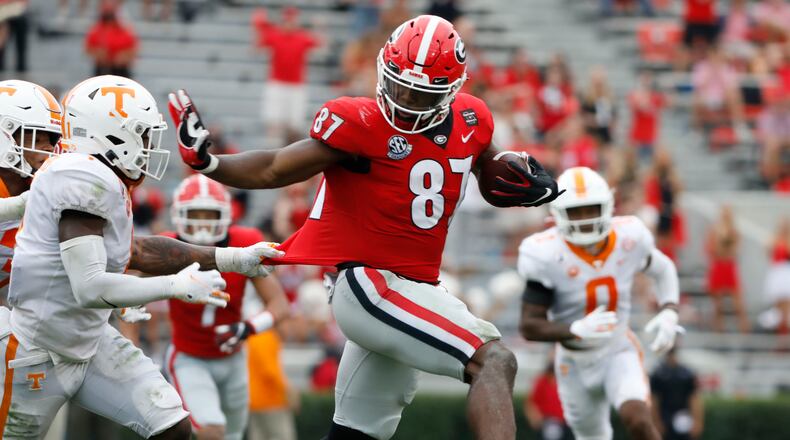 Georgia tight end Tre' McKitty (87) gets some distance from a Tennessee defender for extra yardage Saturday, Oct. 10, 2020, at Sanford Stadium in Athens. (Andrew Davis Tucker/UGA Sports)