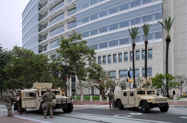 The California National Guard arrives to stand watch outside the Ronald Reagan Federal Building and Courthouse in Santa Ana, Calif., Tuesday, June 10, 2025, after Monday's protests against President Trump's ICE raids resulted in violence. (Mindy Schauer /The Orange County Register via AP)