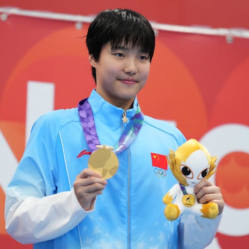 Gold medalist Yu Zidi of China poses on the podium after the women's 200-meter individual medley final in swimming at the Asian Games in Tokyo, Japan, Monday, Sept. 21, 2026. (AP Photo/Hiro Komae)
