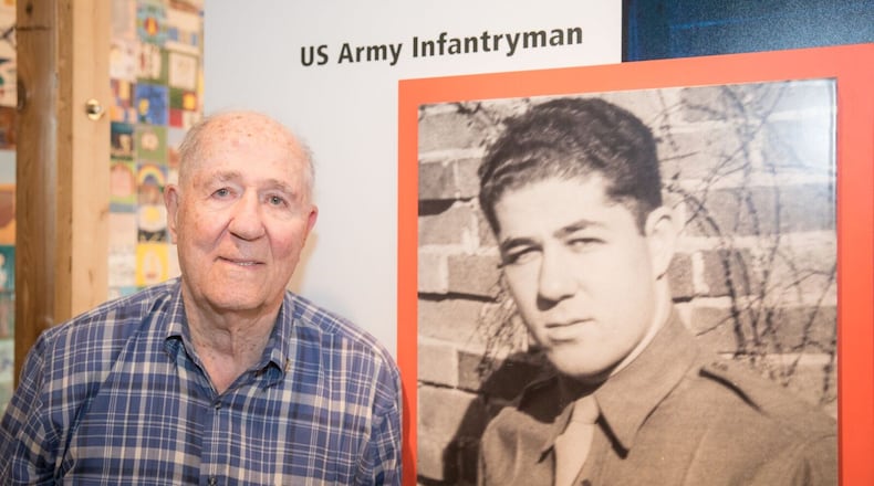 Hilbert Margol, 94, stands beside the display featuring his story in the new “American Witnesses” exhibition at the U.S. Holocaust Memorial Museum in Washington, D.C.