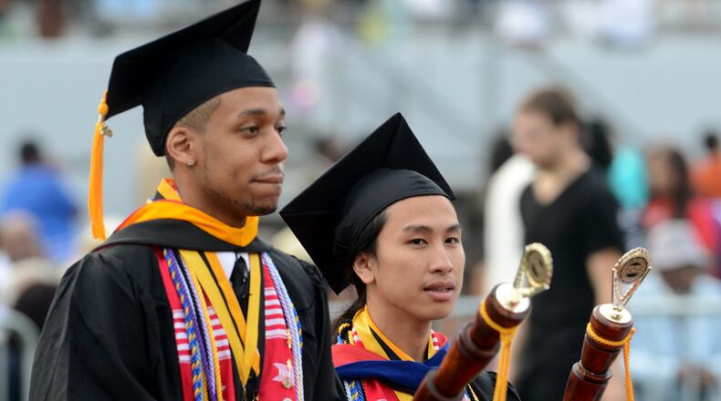Valedictorian Lorin Crawford (left) of Chino Hills, California, mathematics major with a 4.0 GPA, and Salutatorian Tam Quach, of Morrow GA, criminal justice major with a 3.92 GPA, led the graduates into the stadium. The men were freshman roommates and are best friends. Photos from Clark Atlanta University's 24th Annual Commencement Convocation Monday, May 20, 2013 at Panther Stadium. KENT D. JOHNSON / KDJOHNSON@AJC.COM
