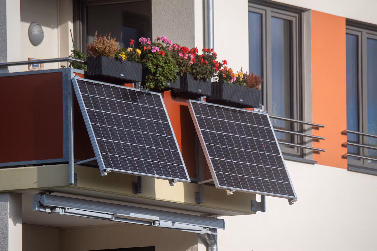 Solar modules for a so-called balcony power plant hang on a balcony. As of Tuesday, citizens in Mecklenburg-Western Pomerania in Germany can apply for funding for so-called plug-in balcony photovoltaic systems. (Photo by Stefan Sauer/picture alliance via Getty Images)