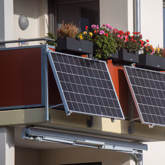 Solar modules for a so-called balcony power plant hang on a balcony. As of Tuesday, citizens in Mecklenburg-Western Pomerania in Germany can apply for funding for so-called plug-in balcony photovoltaic systems. (Photo by Stefan Sauer/picture alliance via Getty Images)