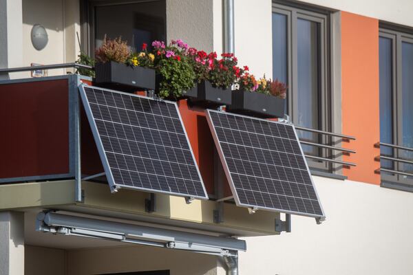 Often called balcony solar, plug-in solar systems plug directly into a standard wall outlet. In most cases, that negates the need for the kind of hardwiring rooftop solar requires. (Photo by Stefan Sauer/picture alliance via Getty Images)