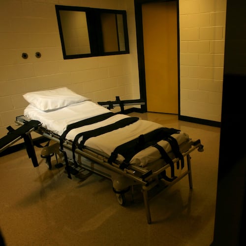 FILE - The gurney used for lethal injections sits behind glass windows in a small cinder block building at the Georgia Diagnostic and Classification Prison in Jackson, Ga., Sept. 7, 2007. (Ben Gray/Atlanta Journal-Constitution via AP, File)