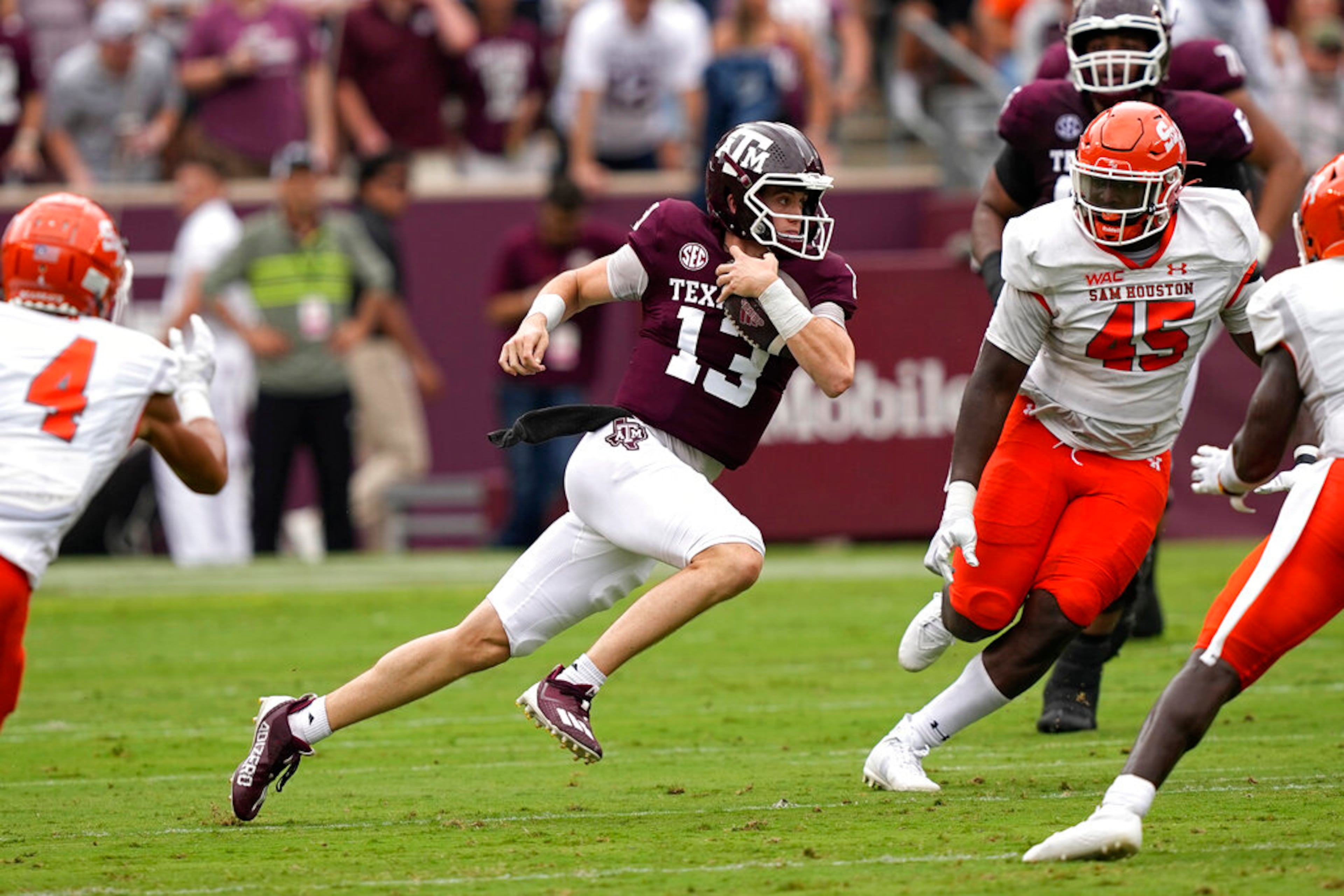 Texas A&M quarterback Haynes King (13) runs for a first down as Sam Houston State's Tyler Moore (45) defends the first half of an NCAA college football game Saturday, Sept. 3, 2022, in College Station, Texas. (AP Photo/David J. Phillip)