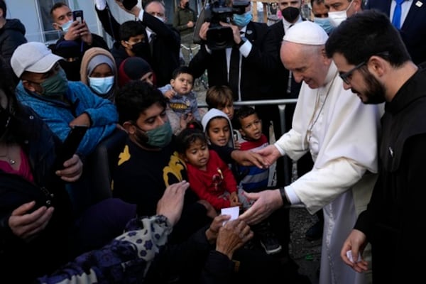 FILE - Pope Francis meets migrants during his visit at the Karatepe refugee camp, on the northeastern Aegean island of Lesbos, Greece, Dec. 5, 2021. (AP Photo/Alessandra Tarantino, file)