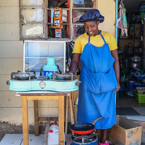 FILE - Grace Kathambi uses a bioethanol fuel stove to fry and sell French fries at her shop in Kibera, an informal settlement on the outskirts of Nairobi, Kenya, on Feb. 4, 2026. (AP Photo/Atieno Muyuyi, File)