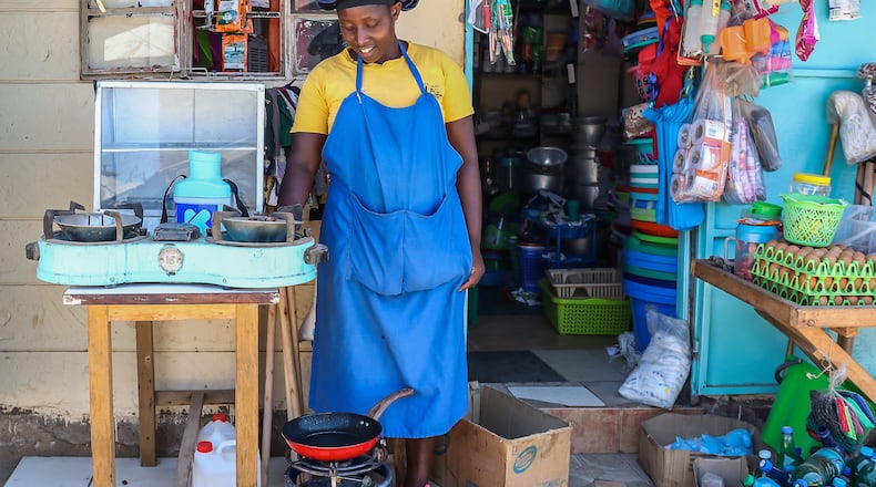 FILE - Grace Kathambi uses a bioethanol fuel stove to fry and sell French fries at her shop in Kibera, an informal settlement on the outskirts of Nairobi, Kenya, on Feb. 4, 2026. (AP Photo/Atieno Muyuyi, File)
