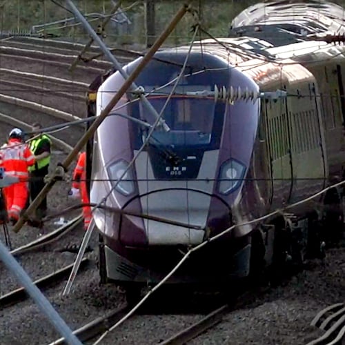 Emergency personnel work on a train on the tracks outside Bedford, England, after a train from Corby to London St. Pancras and another from Nottingham to London St. Pancras, collided on Friday June 19, 2026. (Jamie Lashmar/PA via AP)