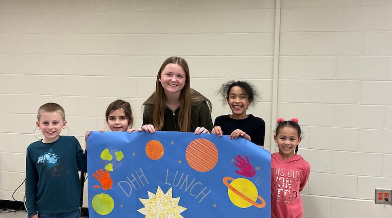HIgh school senior Tess Sheheane (center) created the DHH Lunch Bunch, a program for Cobb County with deafness or hearing loss.