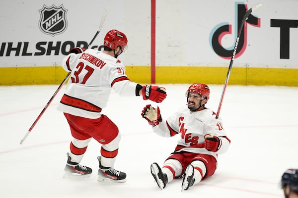 Carolina Hurricanes center Seth Jarvis (24) celebrates his empty net goal with right wing Andrei Svechnikov (37) in the third period of Game 5 of a second-round NHL hockey playoff series against the Washington Capitals Thursday, May 15, 2025, in Washington. (AP Photo/Nick Wass)