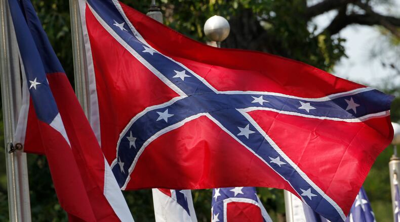 FILE - In this July 19, 2011, file photo, Confederate battle flags fly outside the museum at the Confederate Memorial Park in Mountain Creek, Ala. The Confederate battle flag has been removed from South Carolina's Statehouse grounds, in the wake of the massacre of nine African-Americans, including a state senator, at an historic black church in Charleston in June 2015. (AP Photo/Dave Martin, File)