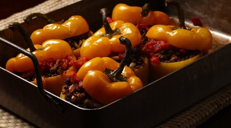 Serbian style stuffed red bell peppers are filled with ground beef, onion, peppers, garlic, pine nuts, rice and raisins.
(E. Jason Wambsgans/Chicago Tribune/TNS)