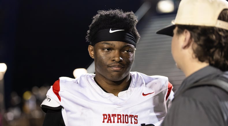 Sandy Creek quarterback Caleb Hill (left) speaks to AJC Varsity reporter Jack Leo after a 21-0 win over Douglas County in August. Sandy Creek is the unanimous No. 1 team in Class 4A, according to the AJC Varsity Composite Rankings, but stands No. 5 in the GHSA Post Season Rankings and is projected to finish as the No. 5 seed, according to the Maxwell Ratings' latest PSR projections. (Oscar Guevara Saenz for the AJC)