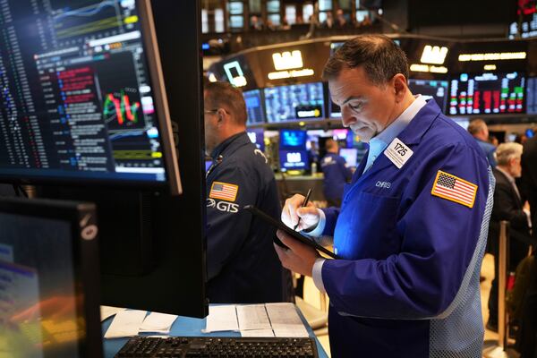 Chris Lagana works on the floor at the New York Stock Exchange in New York, Monday, April 7, 2025. (AP Photo/Seth Wenig)
