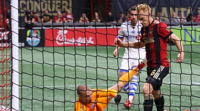 April 28, 2018 Atlanta: Atlanta United midfielder Jeff Larentowicz scores an apparent goal past Montreal Impact goalkeeper Evan Bush but the United were ruled offsides on the play during the first half in a MLS soccer game on Saturday, April 28, 2018, in Atlanta.  Curtis Compton/ccompton@ajc.com