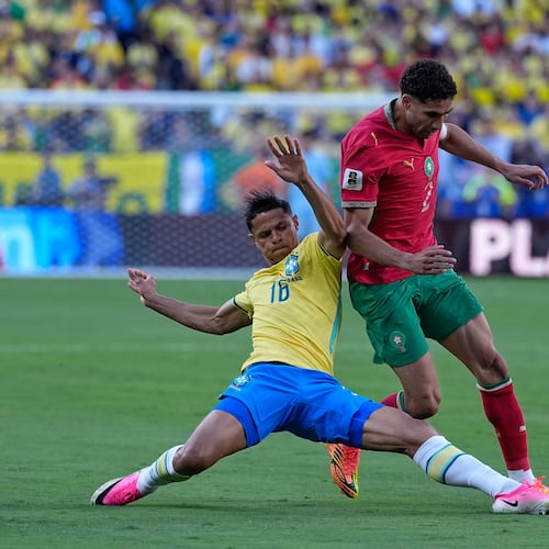 Brazil's Douglas Santos, left, challenges Morocco's Achraf Hakimi during the World Cup Group C soccer match between Brazil and Morocco in East Rutherford, N.J., near New York, Saturday, June 13, 2026. (AP Photo/Petr David Josek)