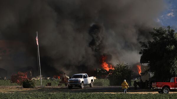 Smoke and flames rise during a fireworks warehouse explosion near Esparto, Calif., Tuesday, July 1, 2025. (Kent Porter/The Press Democrat via AP)