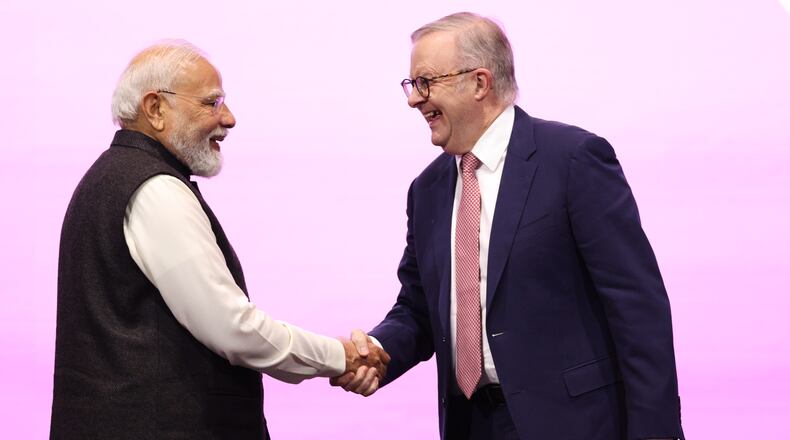 Indian Prime Minister Narendra Modi, left, is welcomed to the stage by Australian Prime Minister Anthony Albanese to address the Australia-India Economic Roadmap Business Reception in Melbourne, Australia, Thursday, July 9, 2026. (AP Photo/Hamish Blair)