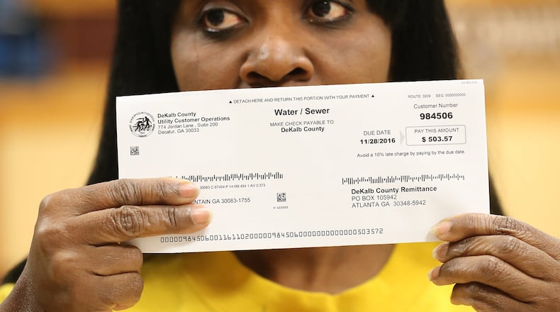 Viola Davis with her DeKalb County water bill for $503.57, demanding answers along with other local residents about excessively high water bills during a town hall meeting on Nov. 10, 2016, in Decatur. Curtis Compton/ccompton@ajc.com