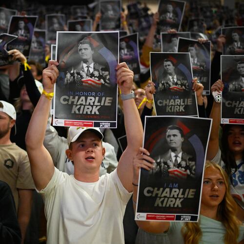 FILE - People hold posters of Charlie Kirk during a Turning Point USA rally at Utah State University, as a part of the organization's push to memorialize Kirk, Sept. 30, 2025, in Logan, Utah. (AP Photo/Alex Goodlett, File)