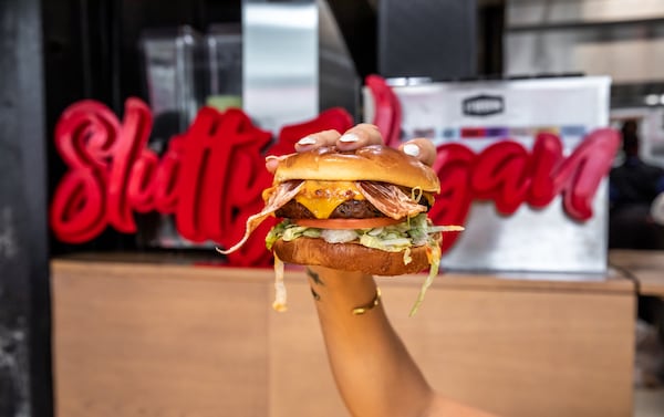 The One Night Stand, a fan-favorite burger from Slutty Vegan, is loaded with vegan bacon, vegan cheese, caramelized onions, lettuce, tomato and "Slut Sauce" on a vegan Hawaiian bun. The popular burger chain has risen to national prominence since its debut as a food truck in 2019. (Courtesy of Madelynne Boykin)
