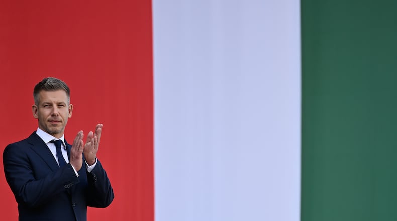 Hungarian Prime Minister Peter Magyar applauds in front of the Hungarian Parliament, after taking his oath of office in Budapest, Hungary, Saturday, May 9, 2026. (AP Photo/Denes Erdos)