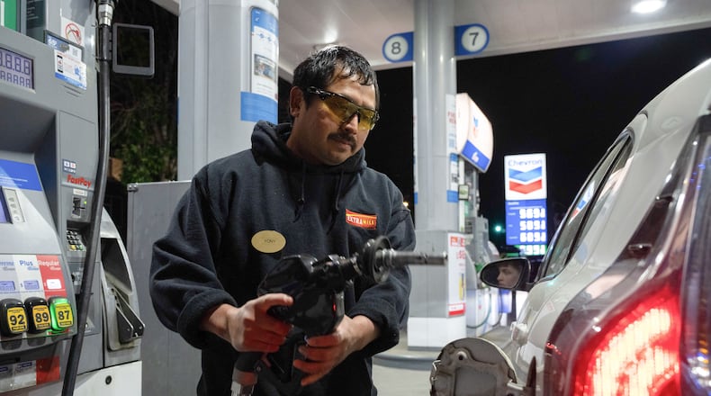 An attendant prepares to fill a customers tank at a gas station on Wednesday, May 6, 2026, in Portland, Ore. (AP Photo/Jenny Kane)