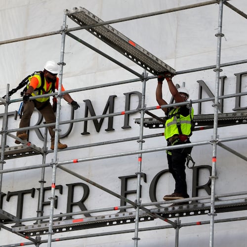 Workers construct scaffolding at the sign for the John F. Kennedy Center for the Performing Arts, Friday, June 12, 2026, in Washington. (AP Photo/Rahmat Gul)