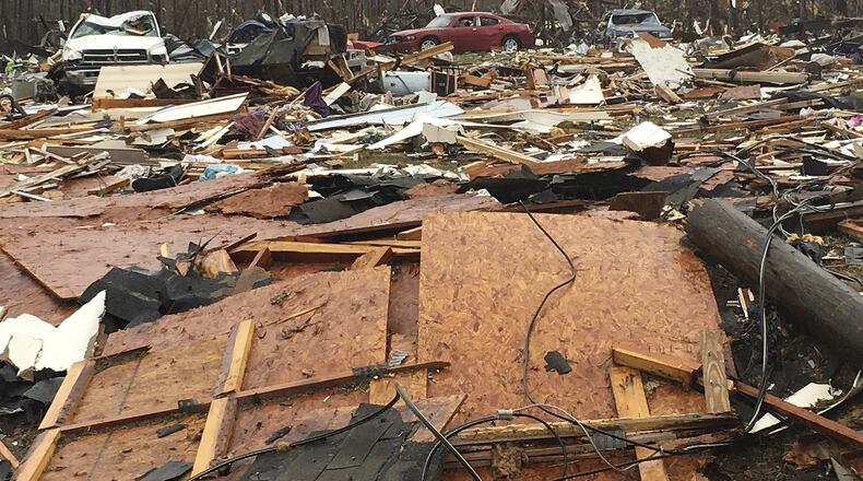 Mobile homes and vehicles lie among the destruction after a tornado struck Sunshine Acres in Adel on Jan. 22. Residents across the South were trying to pick up the pieces left behind by a powerful storm system that tore across the region that weekend, killing more than a dozen people, including several at the Cook County mobile home park. (AP Photo/Brendan Farrington)