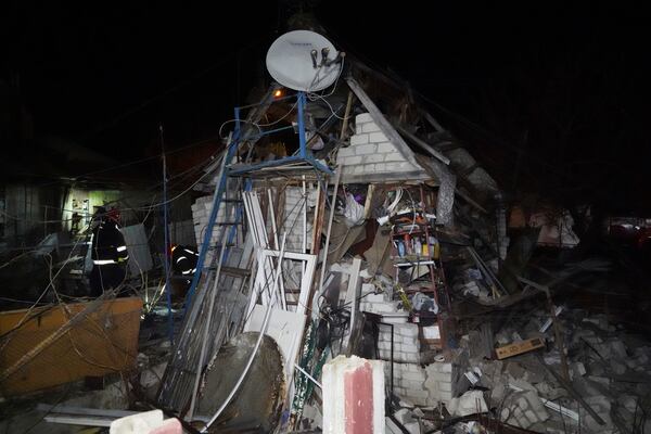 Rescue workers clear the rubble of a house destroyed in a Russian strike on a residential neighborhood of Kharkiv, Ukraine, Saturday, March 29, 2025. (AP Photo/Andrii Marienko)