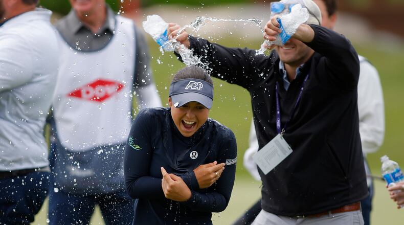 Yana Wilson, center, is doused on the 18th hole after winning the Dow Championship LPGA golf tournament, Sunday, June 14, 2026, at Midland Country Club in Midland, Mich. (AP Photo/Al Goldis)
