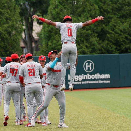 Georgia Bulldog players gather in the outfiled moments before they face the Mississippi State Bulldogs for Game 2 of the NCAA Super Regional at Foley Field on Sunday, June 7, 2026, in Athens. (Miguel Martinez/AJC)