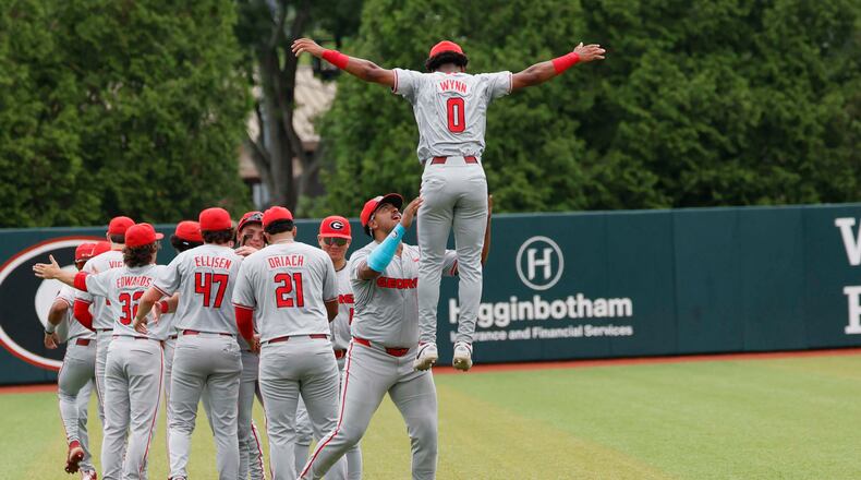 Georgia Bulldog players gather in the outfield moments before they face the Mississippi State Bulldogs for Game 2 of the NCAA Super Regional at Foley Field on Sunday, June 7, 2026, in Athens. (Miguel Martinez/AJC)