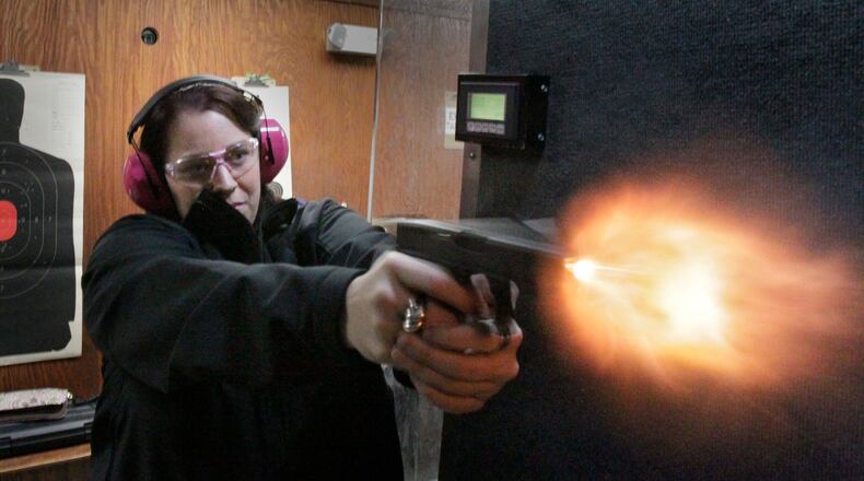 Sydni Lee fires her Glock 19 at a gun range in Cumming in 2013. A Massachusetts man says he was target practicing with a Glock when it exploded in his hands, seriously injuring him. BOB ANDRES BANDRES@AJC.COM