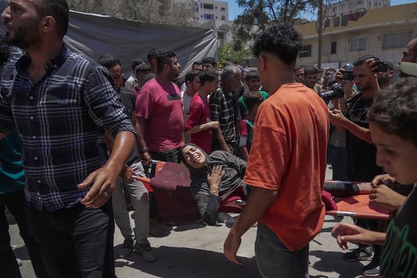 A woman is evacuated after an Israeli strike on tents sheltering displaced Palestinians in Gaza City on Tuesday, July 8, 2025. (AP Photo/Jehad Alshrafi)