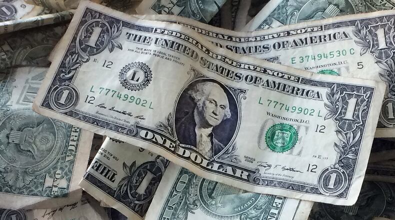 FILE - This Oct. 24, 2016 file photo shows dollar bills in New York. After you pay your bills in 2020, will there be any money left for relaxation and entertainment? Will you be able to take a vacation this year? How much can you afford to spend on clothes? These questions may come to mind as you think about your money plans for the new year, but there's a way to budget for fun in 2020. Financial pros share tips for how to achieve balance in your budget using the 50/30/20 rule and other financial techniques. (AP Photo/Mark Lennihan, File)