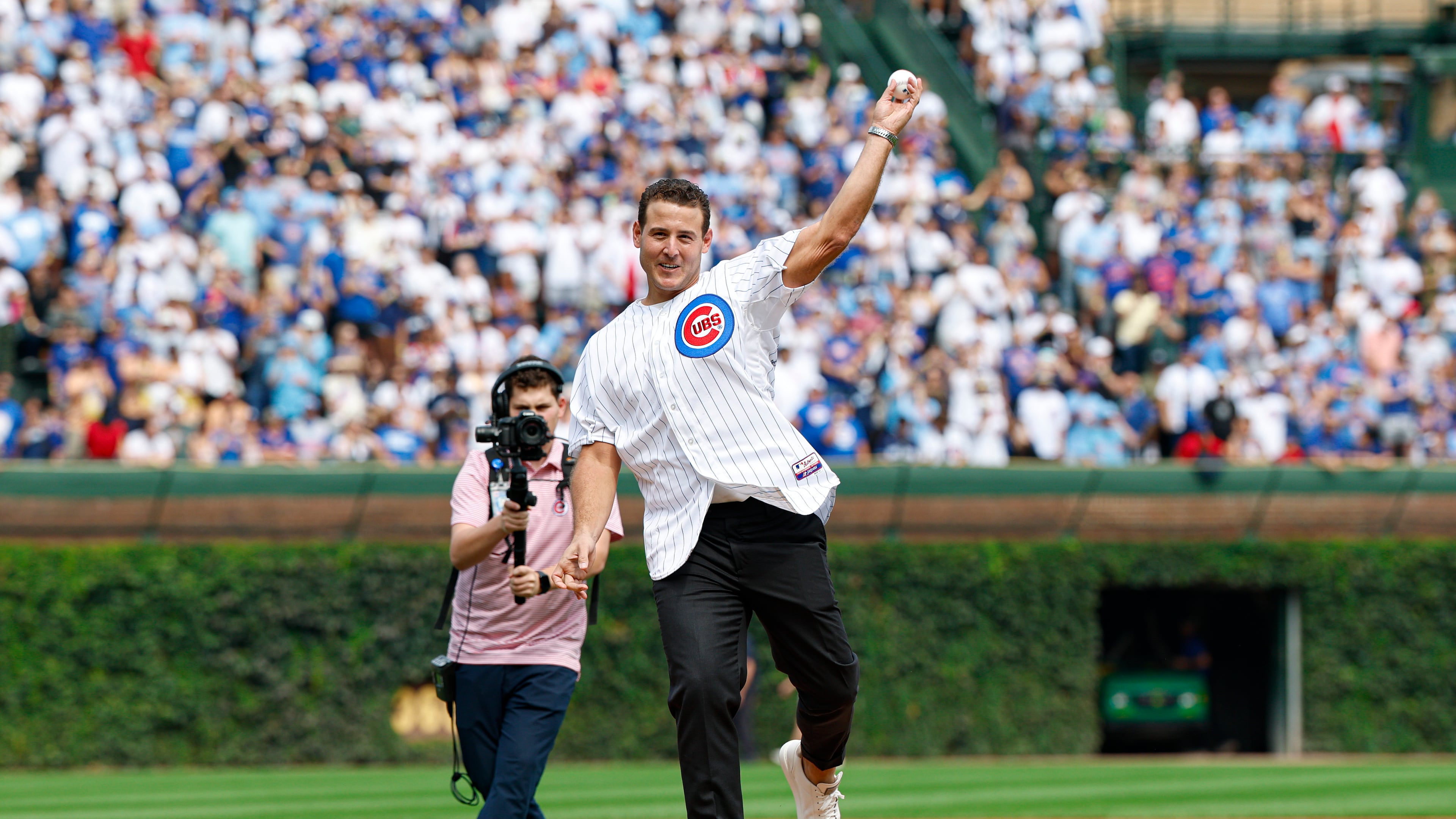 Former Chicago Cubs player Anthony Rizzo throws out a ceremonial first pitch before a baseball game between the Tampa Bay Rays and Chicago Cubs, Saturday, Sept. 13, 2025, in Chicago. (AP Photo/Kamil Krzaczynski)