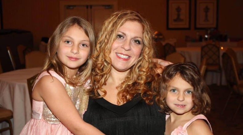 Sally Mundell, with her daughters Ruby, left, and Matilda. Mundell, 38, founded The Packaged Good soon after her husband, Grover, passed in 2013. The nonprofit, which will hold its grand opening Saturday, seeks to inspire children to give. CONTRIBUTED BY SCENESATIONS PHOTOGRAPHY