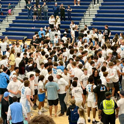 Cambridge students, fans and players celebrate the boys basketball team's 56-45 win over East Forsyth in the Class 4A state tournament quarterfinals in Milton. (BJ Sweeney/AJC)