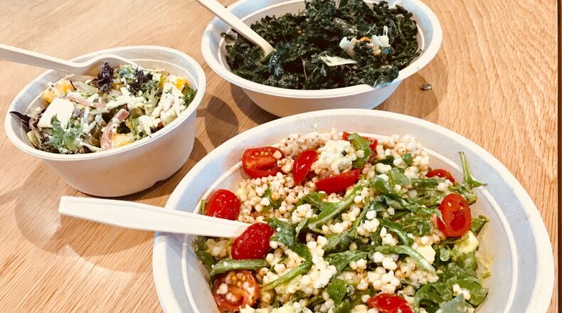 Salads from Wildleaf. Clockwise from left: Create-your-own with artisan greens, mango, jicama, green papaya, pickled red onion and queso fresco; Catalan salad with Tuscan kale, Medjool dates, hazelnuts and Manchego cheese; and Ancient Grains salad with sorghum seed, wild arugula, avocado, cherry tomatoes and basil. / Photo credit: Ligaya Figueras